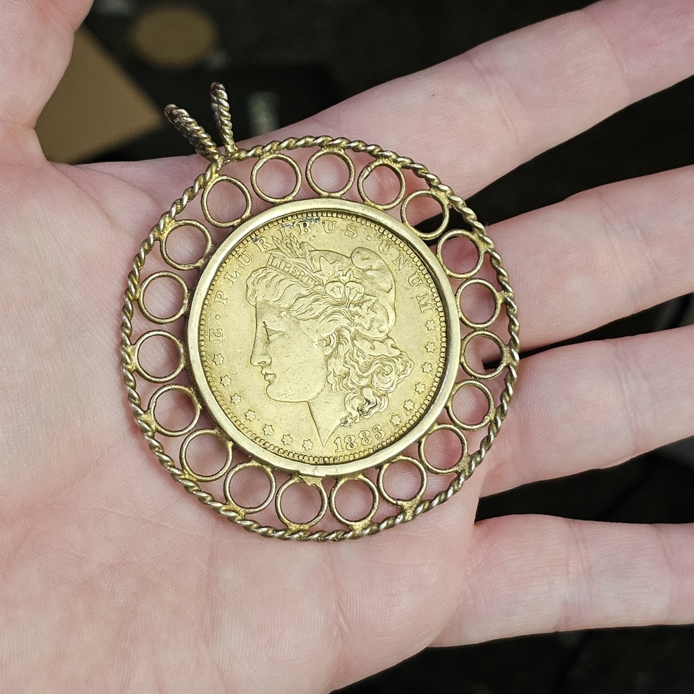 Morgan dollar coin pendant 1883. The case around the coin tests as sterling silv